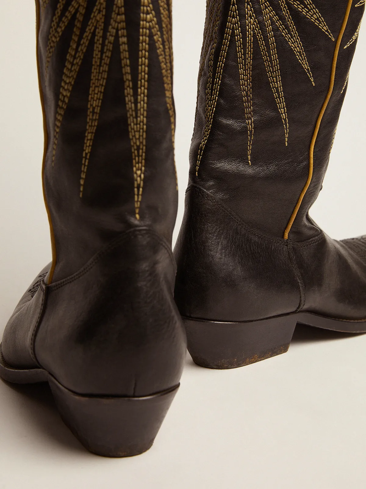 Women's boots in black leather with platinum star inlay